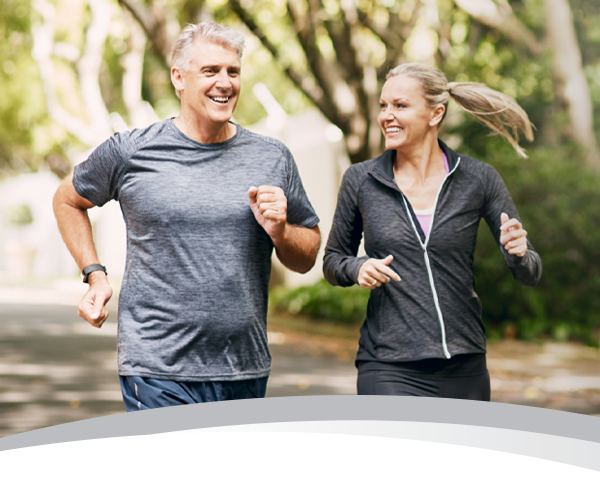 Photo of an older couple jogging outdoors